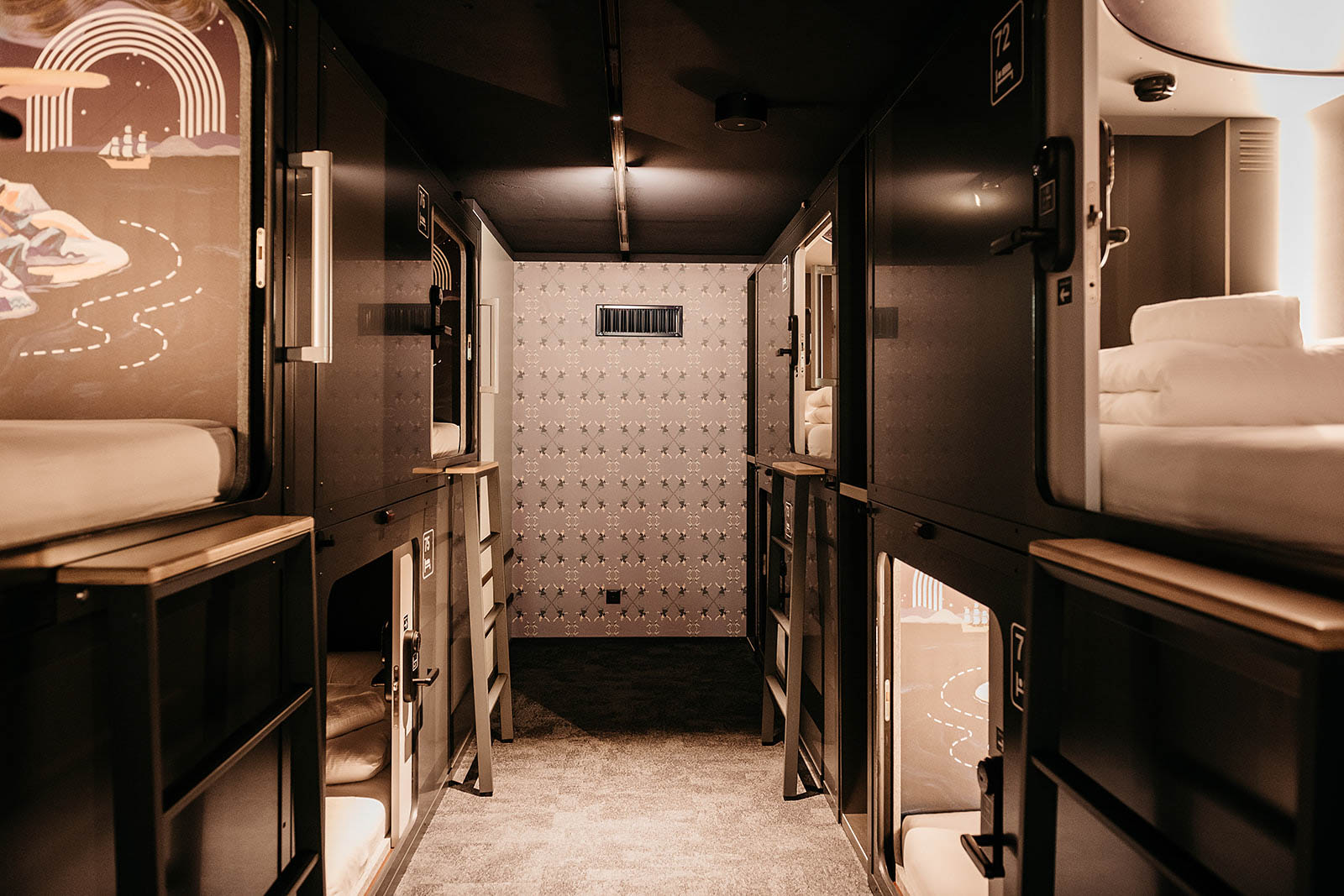 Capsule dorm with modern design and mural art walls at Capsule Hotel Lucerne Old Town.