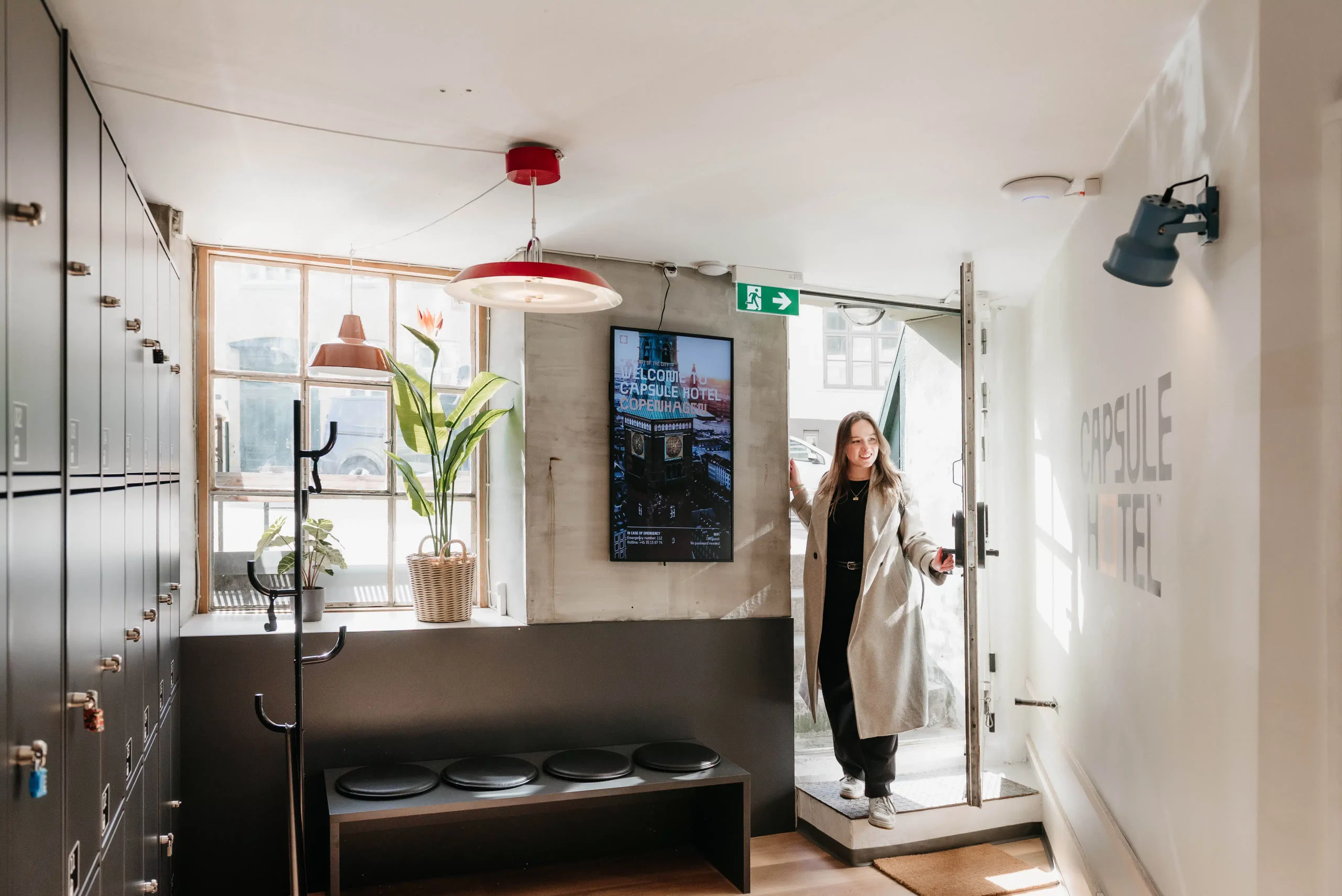 Lobby entrance at Capsule Hotel Copenhagen Vesterbro with modern decor and lockers.