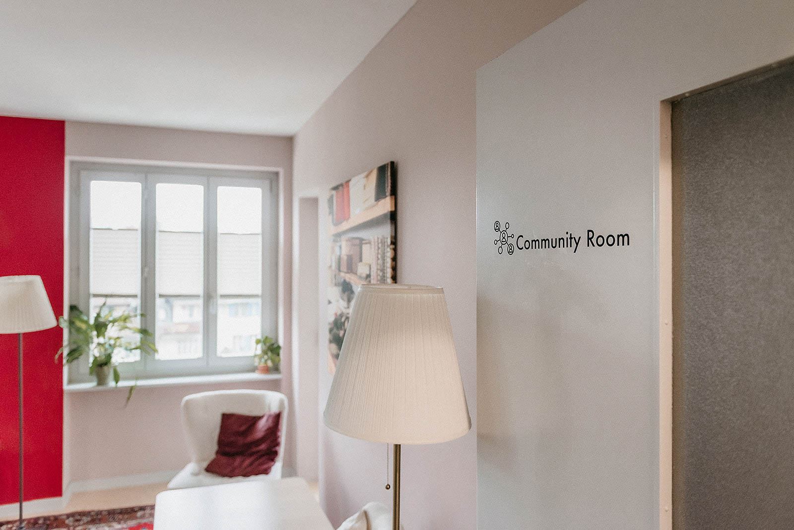 Community Room entry with seating and plants at Capsule Hotel Lucerne The Lab.