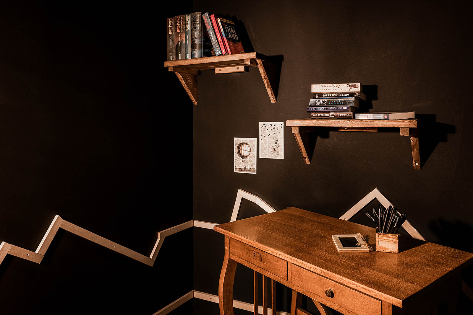 Cozy reading nook with wooden desk and shelves, Capsule Hotel Alpine Garden Zurich Airport.