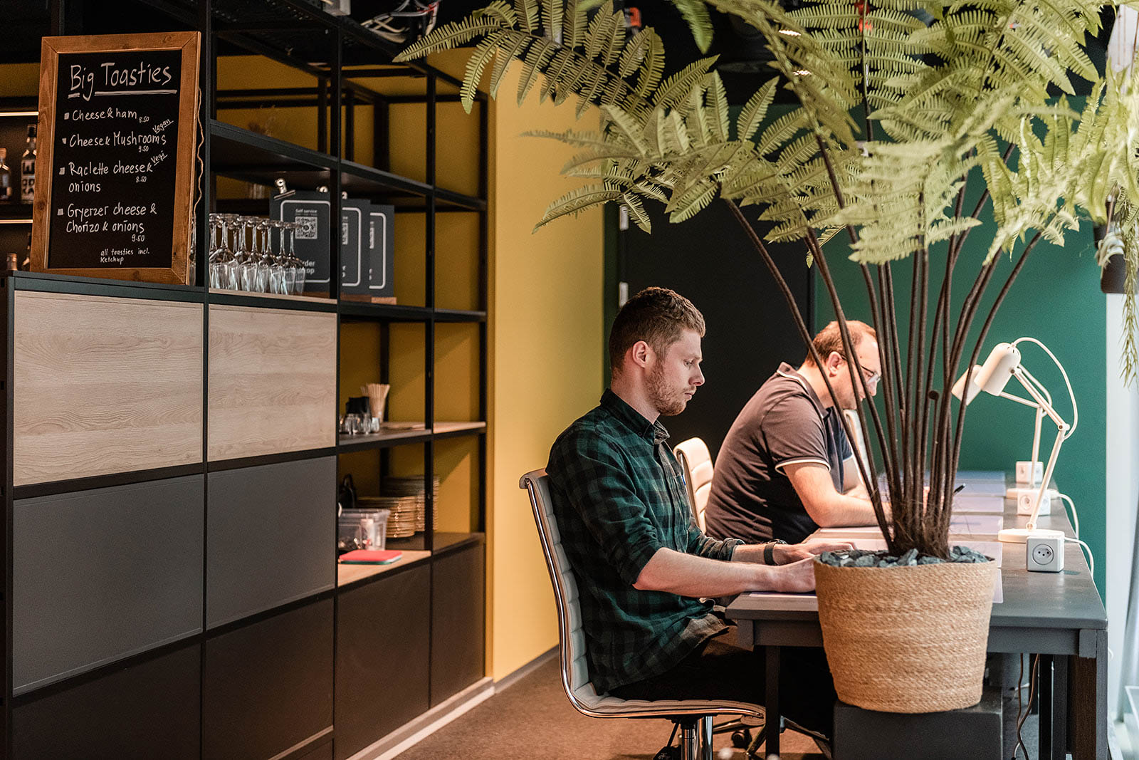 Workspace with two people at desks, Capsule Hotel Alpine Garden Zurich Airport.
