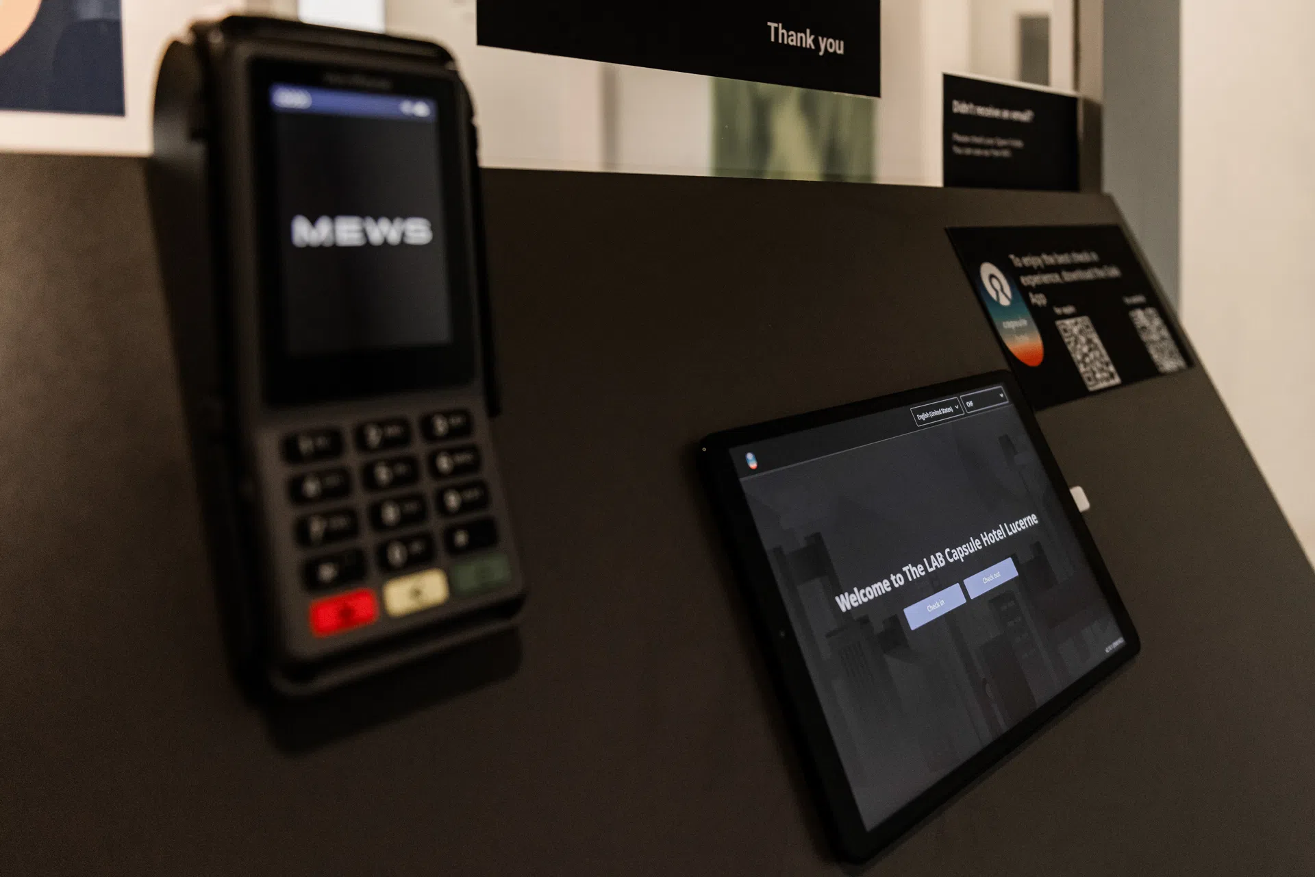 Tablet for self-check-in at Capsule Hotel Lucerne reception area. Digital convenience for seamless guest experience.