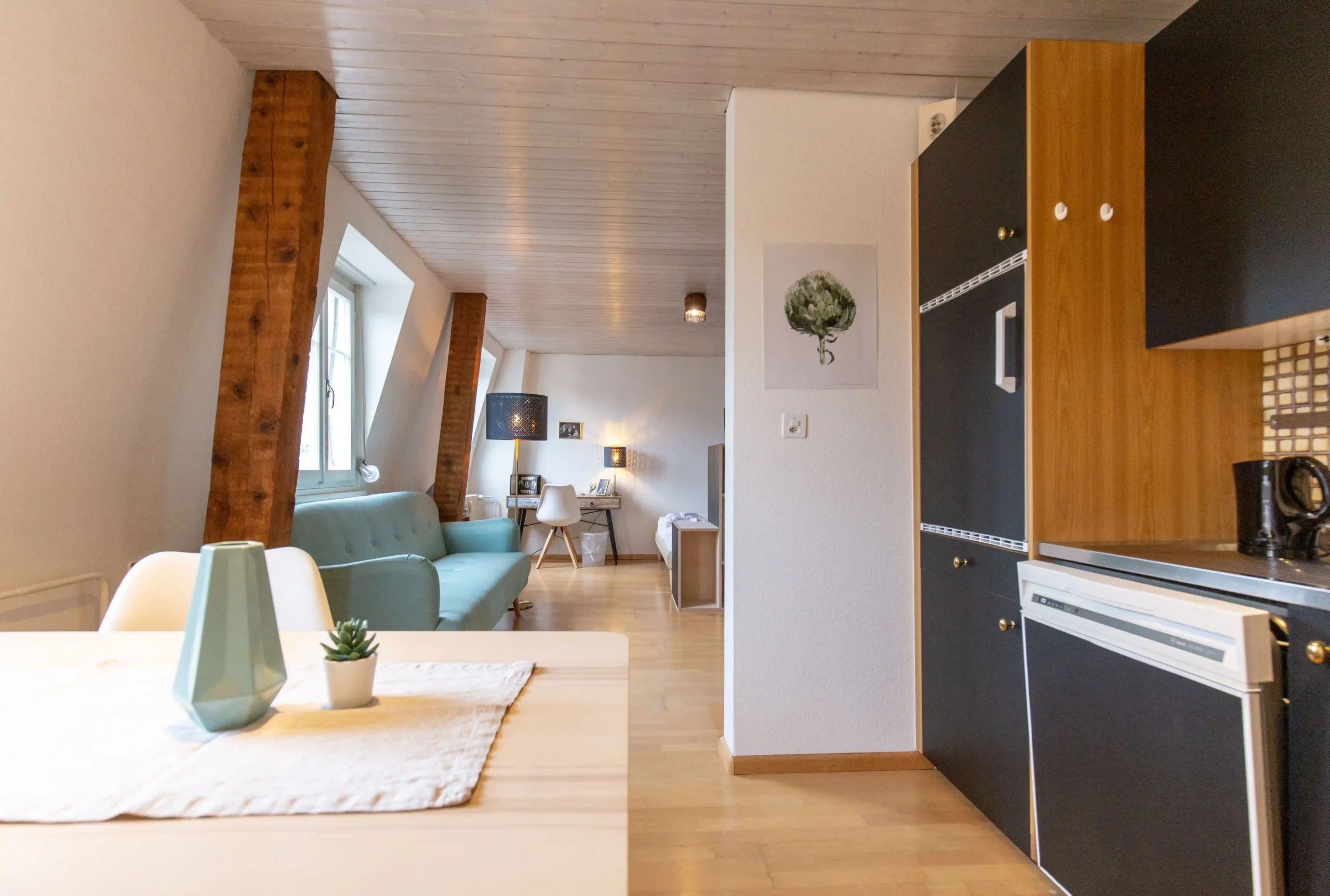 Modern lounge space at Capsule Hotel with sleek furnishings, wooden accents, and minimalist decor.