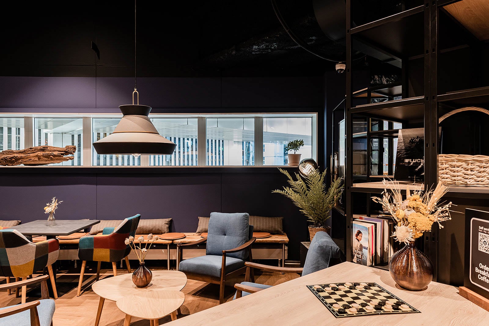 Cozy lounge seating area with modern decor at Capsule Hotel Alpine Garden Zurich Airport.